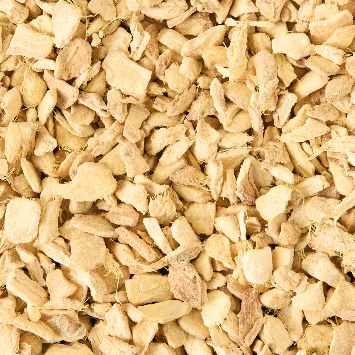 A close-up view of Pure Ginger Loose Infusion, highlighting its numerous small pieces of dried ginger root with a light tan color and a rough, irregular texture. The overlapping pieces completely fill the frame.