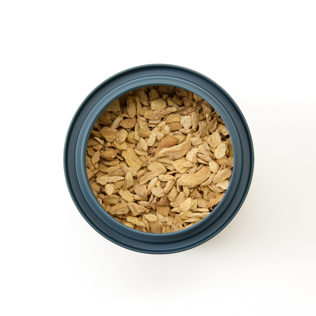 Top view of Pure Ginger Loose Infusion, a blue container filled with dried ginger root slices set against a plain white background—an ideal option for enjoying authentic pure ginger flavor.
