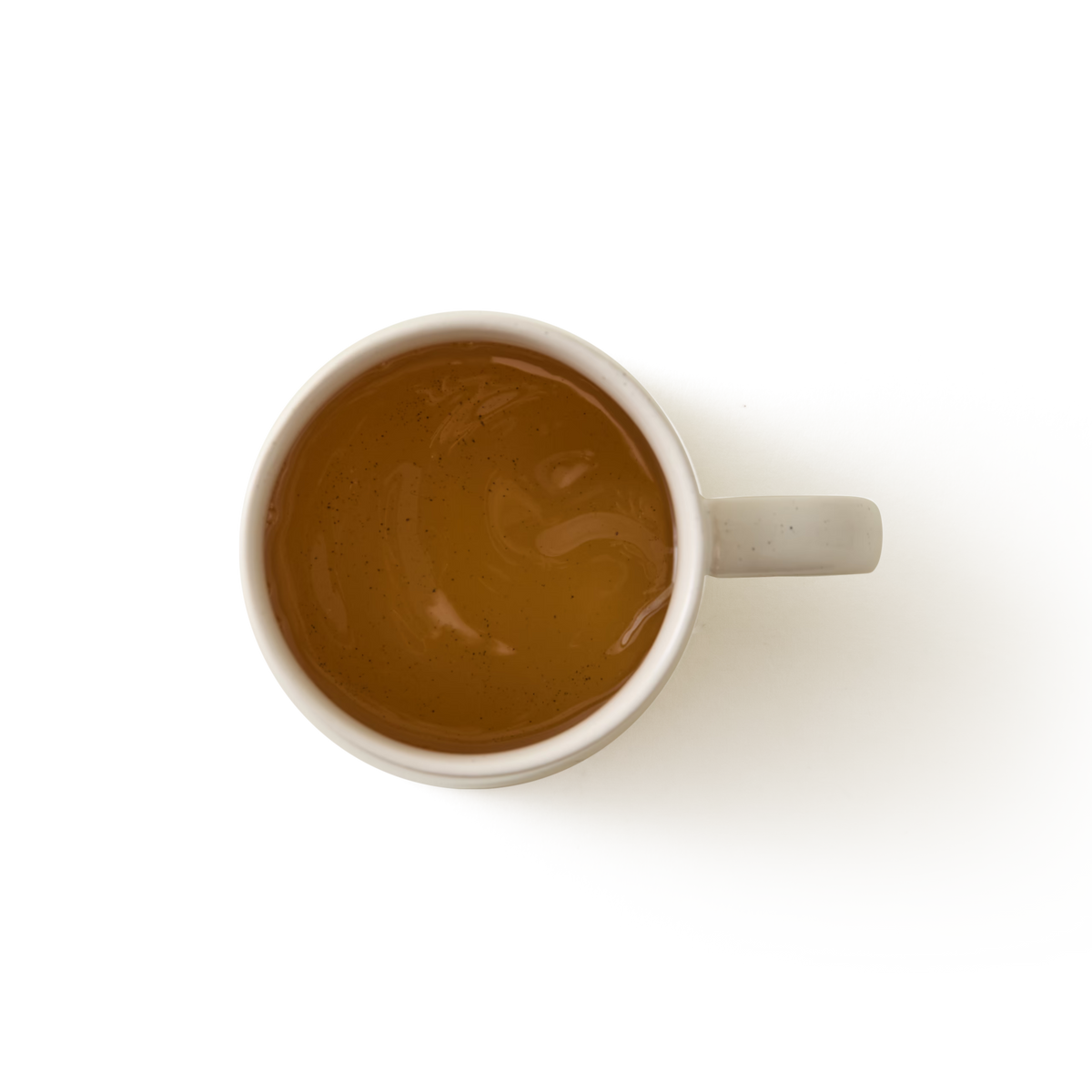 An Arran Mug in a large cream glaze stoneware finish, filled with light brown tea and viewed from above on a plain white background.