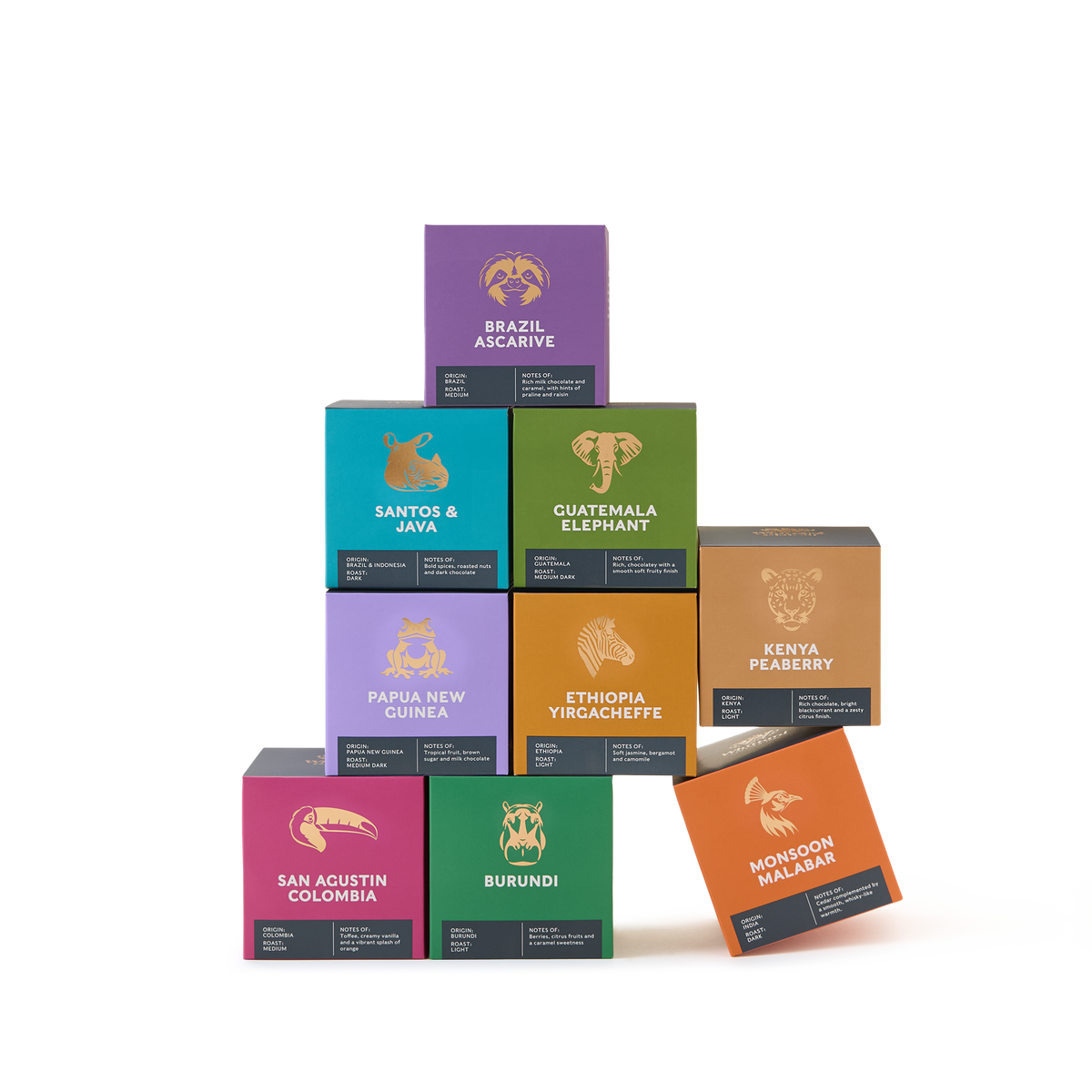 Nine colorful coffee boxes from the Coffees of the World Gift Set are stacked in a pyramid shape, each labeled with a country or region name and featuring an illustrated animal on the front—a vibrant showcase of global coffee origins. The plain white background highlights this exceptional collection.