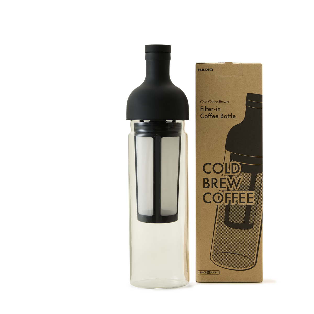 A glass cold brew coffee bottle with a black lid and filter stands next to its brown packaging box labeled COLD BREW COFFEE on a plain white background.