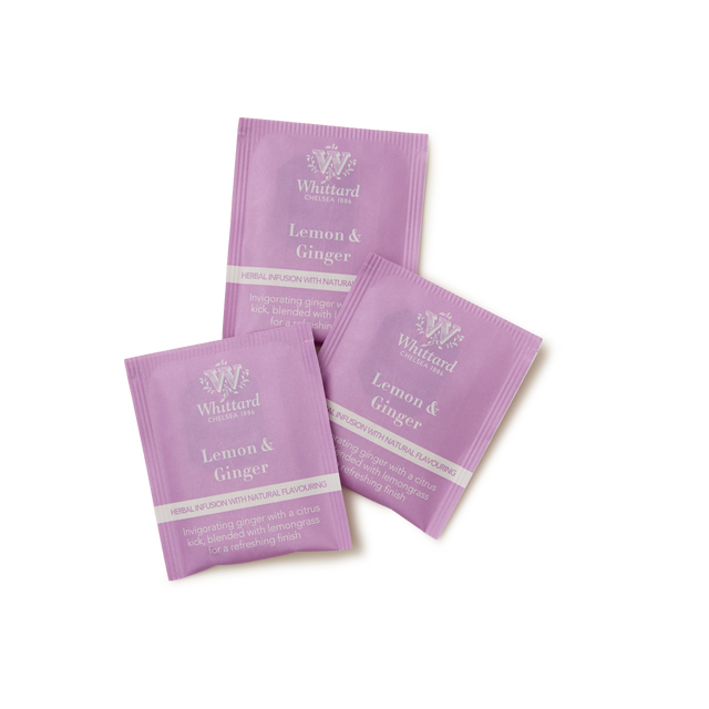 Three purple sachets of Whittard Lemon & Ginger Infusion Teabags are arranged on a white background. The sachets display the brand name and product name in white text, along with a brief description of the tea blend.