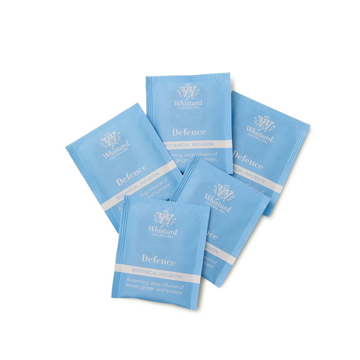 Five blue Whittard of Chelsea Defence botanical infusion tea sachets are arranged in a fan shape on a white background.