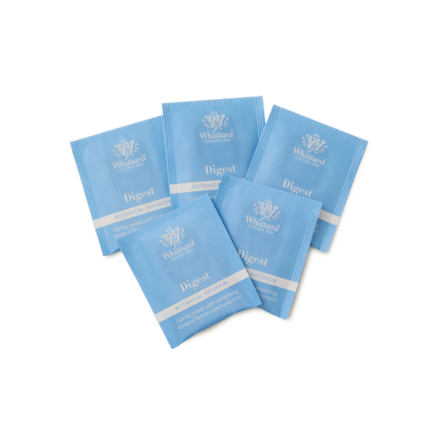 Five blue Whittard Digest botanical infusion tea sachets are arranged in a fan shape on a white background.