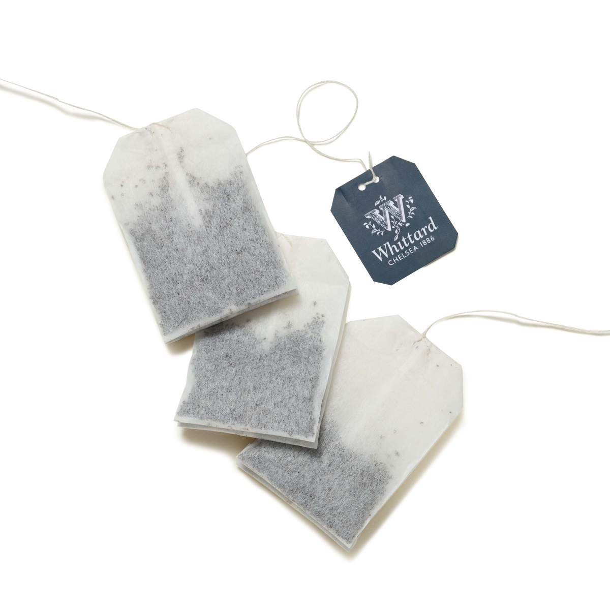 Three Relax Botanical Wellness Infusion Teabags with white strings and a blue Whittard Chelsea 1886 tag are arranged on a white background, ready to create a calming infusion.