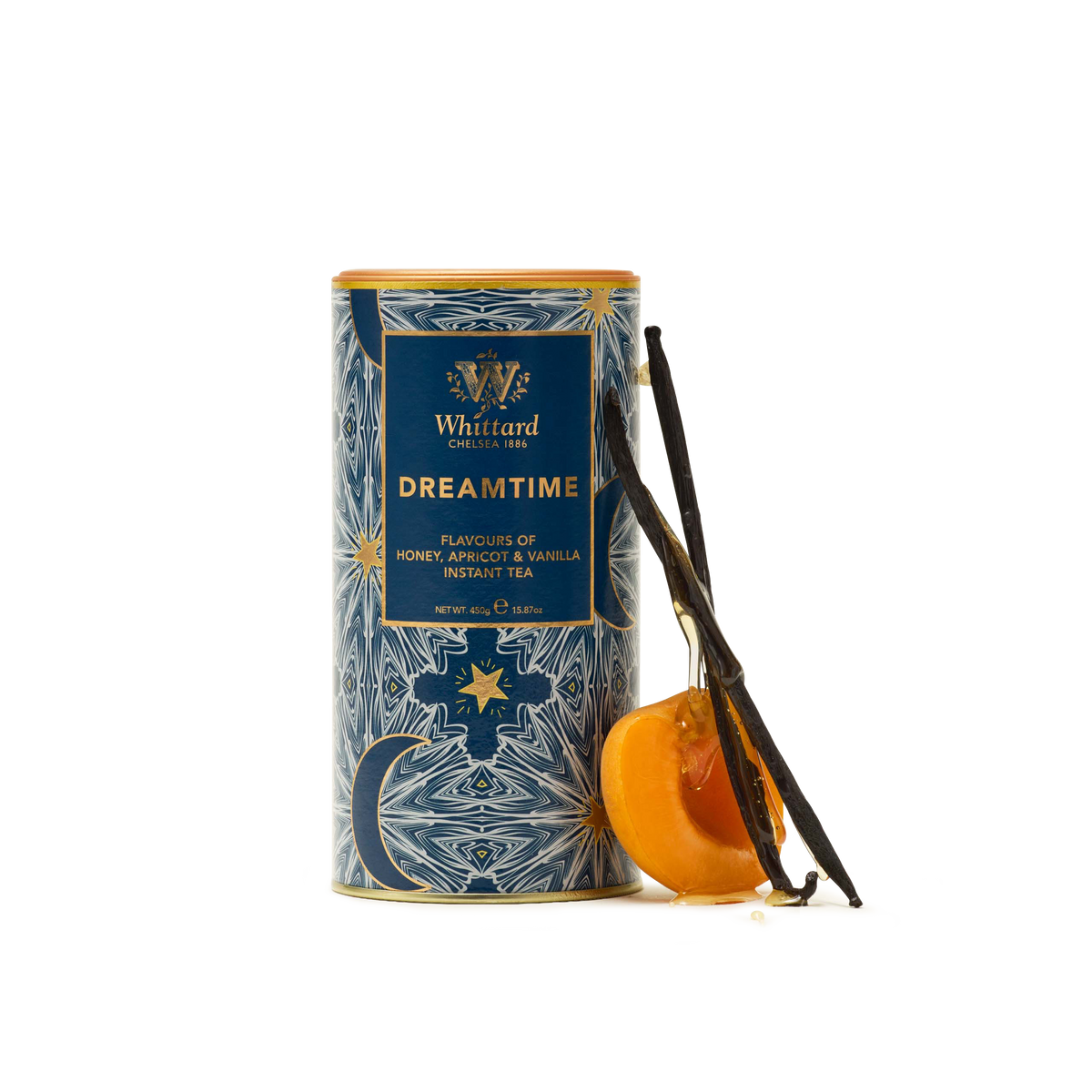 A cylindrical tin of Whittard Dreamtime tea with blue and gold celestial designs, next to a vanilla pod and a sliced apricot.