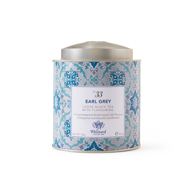 A decorative Tea Discoveries Earl Grey Caddy, featuring Whittard’s signature blue patterned tin with a silver lid set against a white background. The label highlights the infusion of fragrant bergamot with fine Ceylon black tea and essential tea flavoring, along with information on contents.