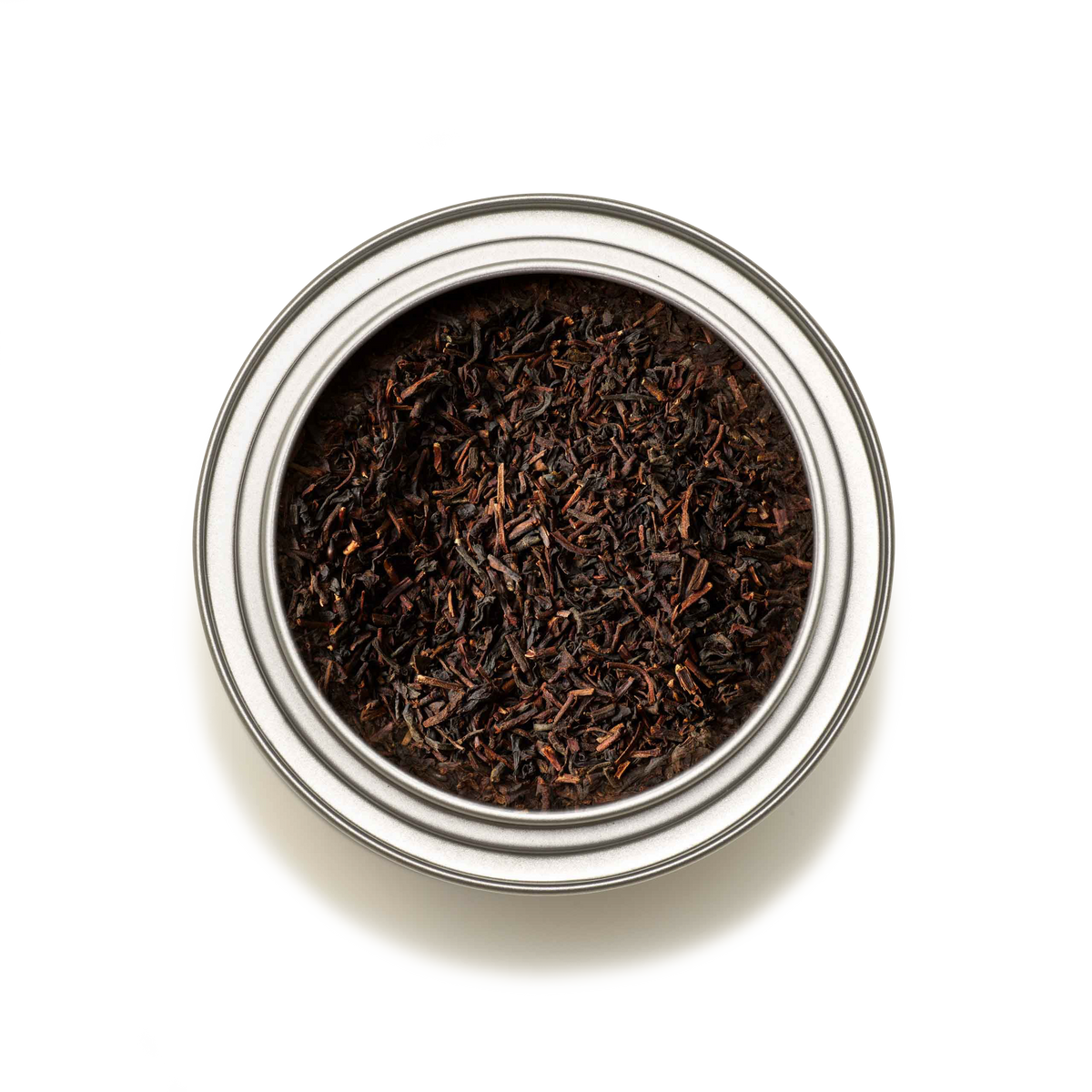 A top-down view of the Tea Discoveries English Breakfast Tea Caddy, filled with loose English Breakfast tea leaves, set against a white background.