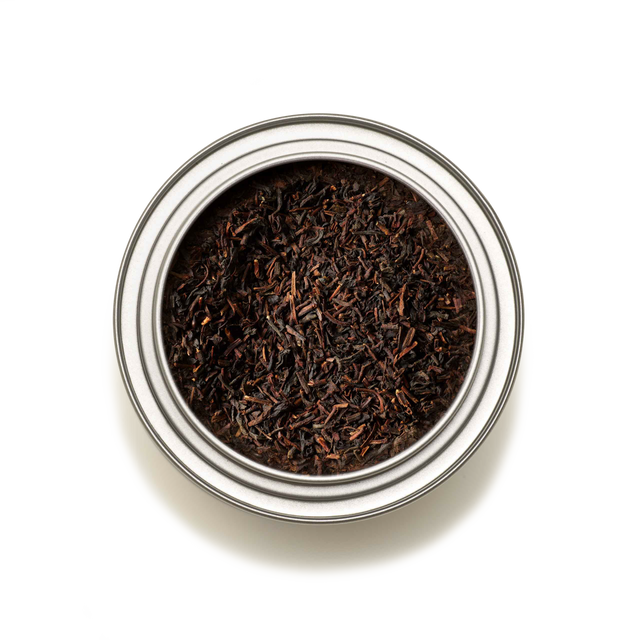 A top-down view of the Tea Discoveries English Breakfast Tea Caddy, filled with loose English Breakfast tea leaves, set against a white background.