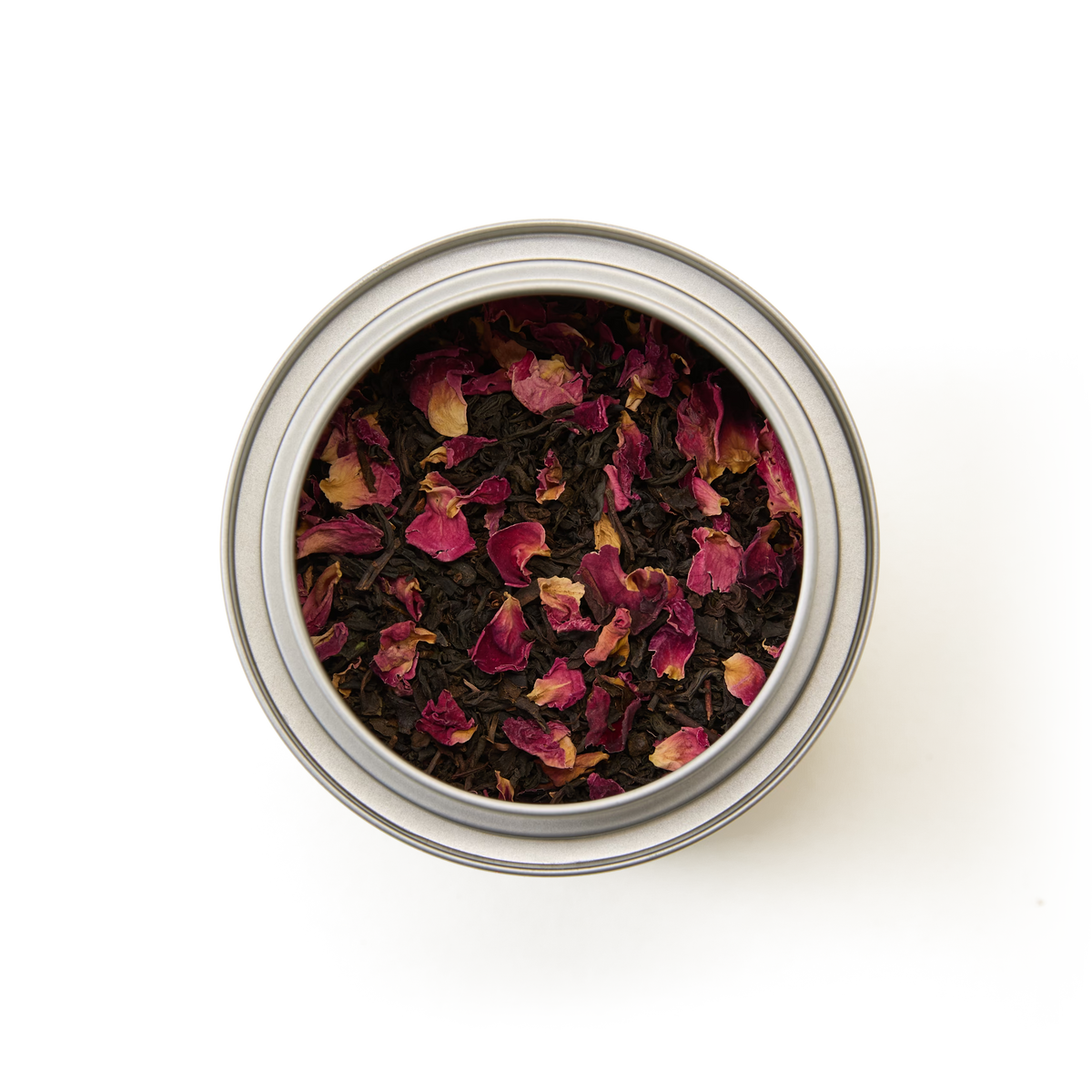 A Tea Discoveries English Rose Tea Caddy—a round metal tin filled with loose leaf English Rose tea, delicately blended with dried pink rose petals—viewed from above on a white background.