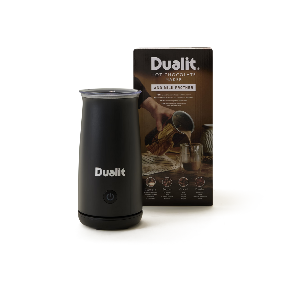 A black Dualit hot chocolate maker sits in front of its packaging box, which shows an image of hot chocolate being poured into a glass.