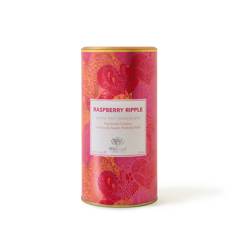 A cylindrical tin of Raspberry Ripple Flavour Hot Chocolate features a pink and red patterned design with a central white label, perfectly capturing the sweet indulgence of this unique white hot chocolate blend.