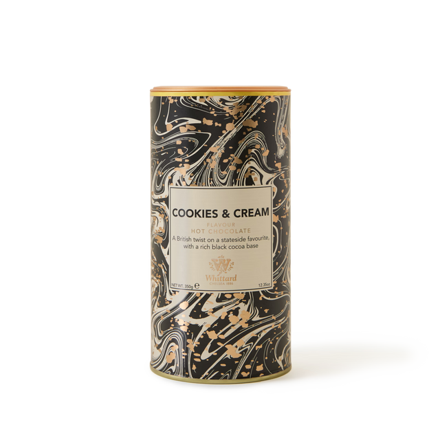 A cylindrical tin of Cookies and Cream Flavour Hot Chocolate, showcasing a black, white, and gold marbled design with a beige front label—combining the rich flavours of cookies and cream with notes reminiscent of chocolate biscuits.