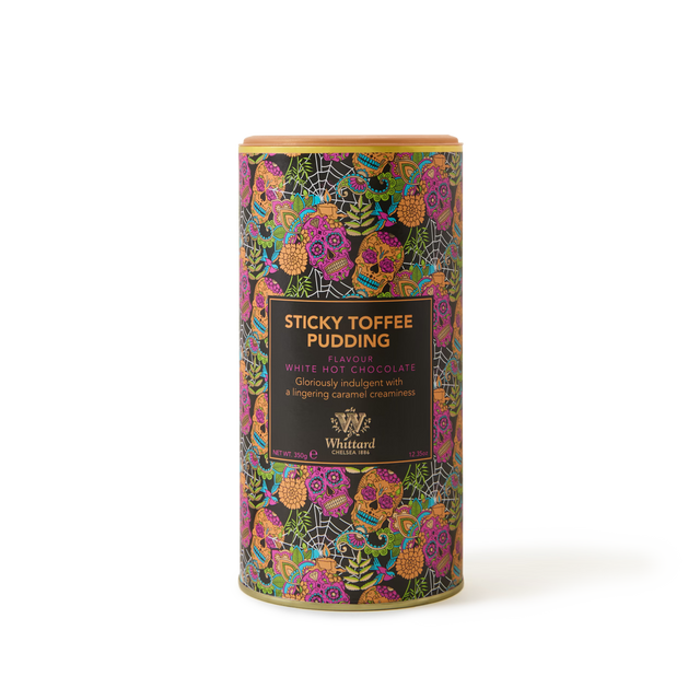 A cylindrical tin of Whittard Sticky Toffee Pudding white hot chocolate, featuring a colorful floral and leaf pattern with a dark label describing the flavor and creamy texture.