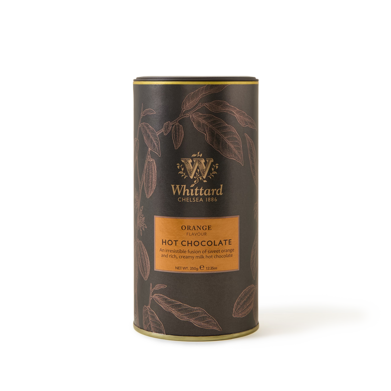A cylindrical container of Whittard Orange Flavour Hot Chocolate, featuring a dark brown design with orange accents and illustrations of cocoa leaves.