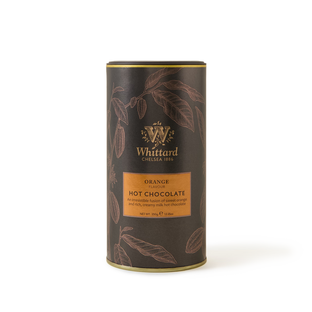 A cylindrical tin of Whittard Orange Flavour Hot Chocolate, adorned with a dark brown design, gold accents, and illustrated cocoa pods. The label emphasizes the vibrant orange flavour with citrus notes alongside the rich taste of cocoa, and displays a net weight of 350g.