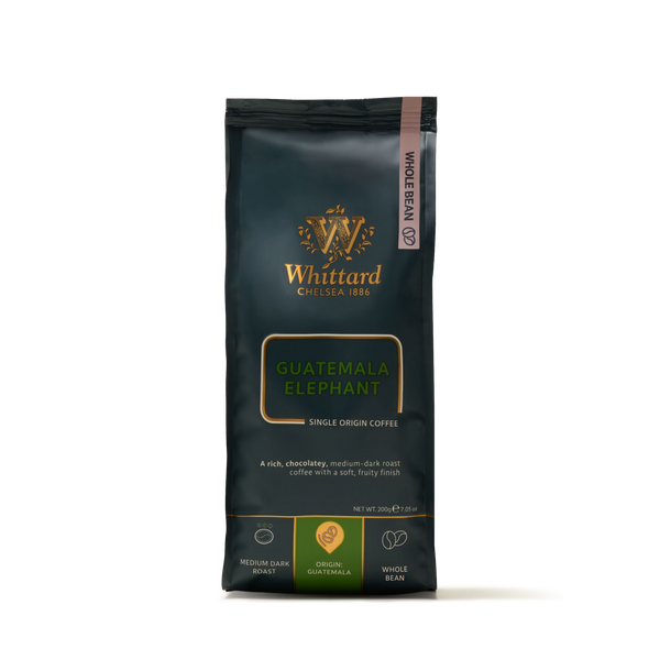 A 200g valve pack of Whittard Guatemala Elephant Coffee Beans—single origin, whole bean coffee from the volcanic slopes of Guatemala. The dark packaging, accented with gold and green, highlights its medium dark roast and distinctive origin. Featuring large beans renowned for their bold flavor, this coffee truly captures the essence of its unique growing region.