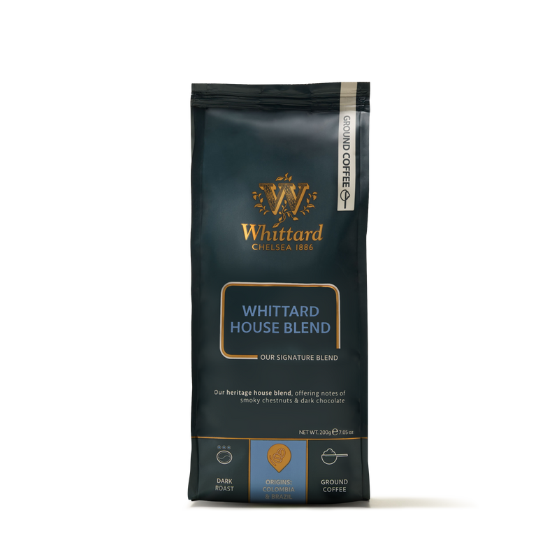 A bag of Whittard Chelsea 1886 Whittard House Blend ground coffee, dark roast, 200g. The packaging is dark with gold and blue accents, featuring blend details and origin information at the bottom.