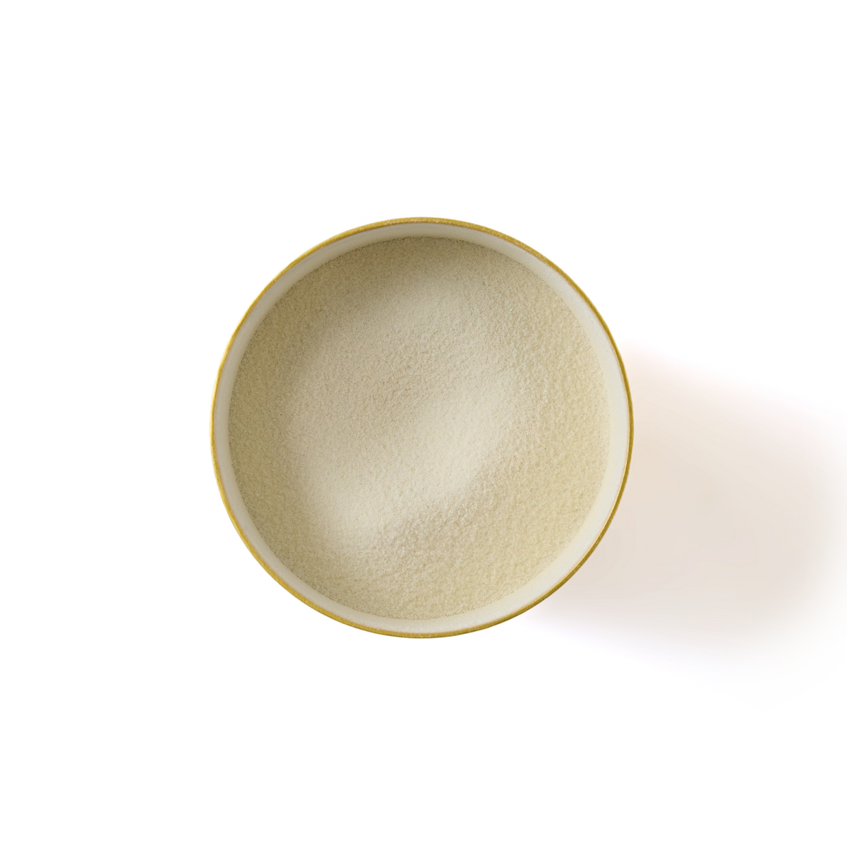 A round bowl filled with fine, off-white Pistachio Flavour White Hot Chocolate powder—perfect for making a creamy white chocolate drink—viewed from above on a white background.
