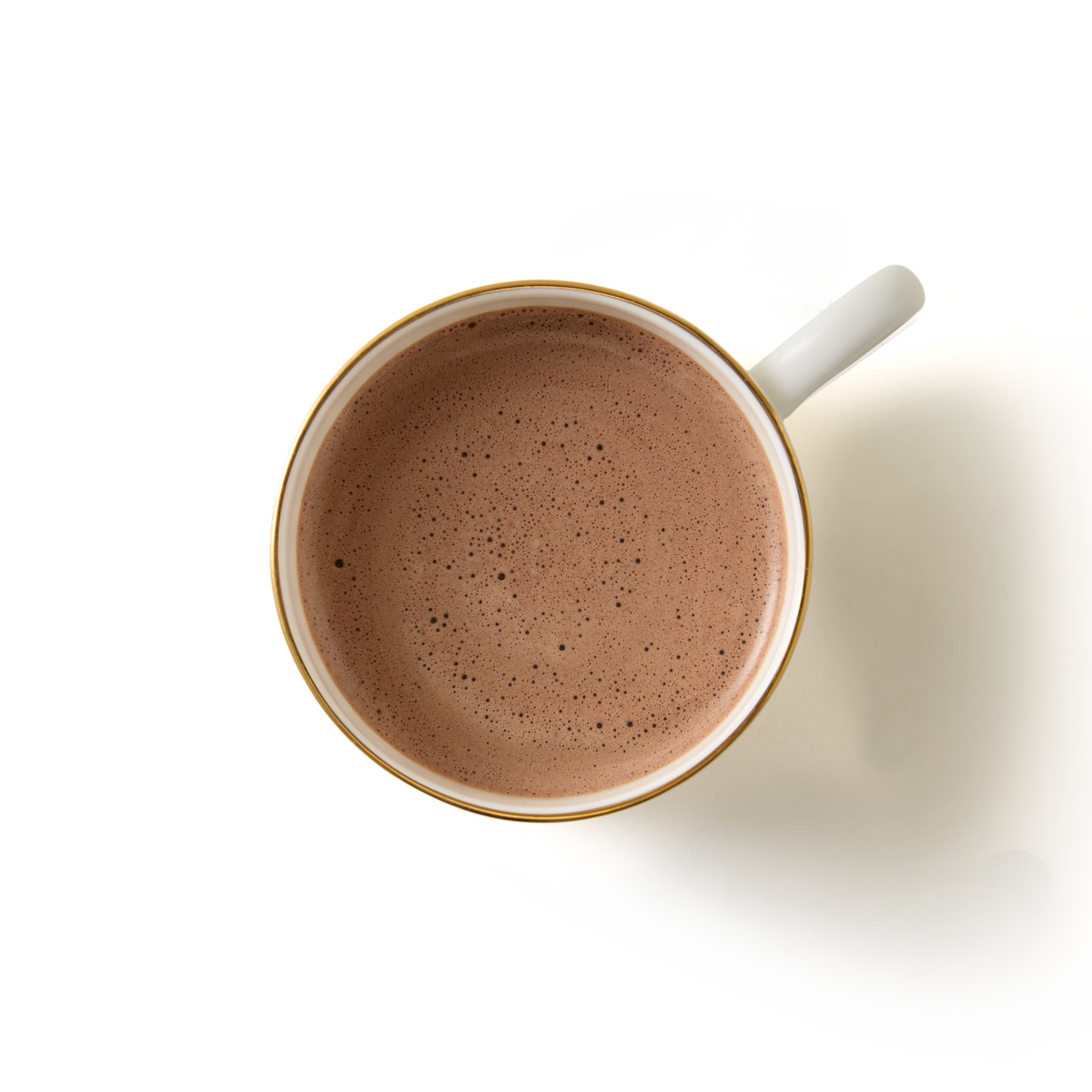 A top-down view of a cup filled with frothy hot chocolate on a white background.