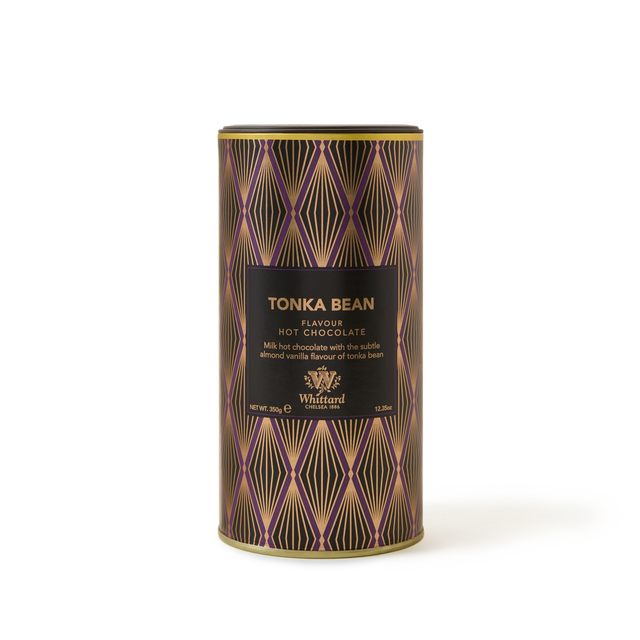 A cylindrical tin of Tonka Bean Flavour Hot Chocolate featuring a black and gold geometric design and product details on the front, this gourmet hot chocolate delivers a rich, indulgent tonka bean experience.