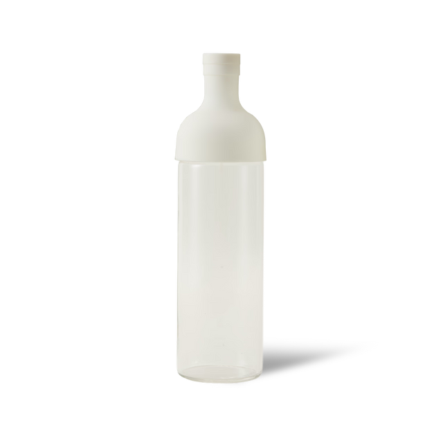 The White Hario Cold Brew Tea Bottle is a clear, cylindrical plastic bottle with a white, rounded cap, standing upright on a white background with a faint shadow to the right—perfect for preparing refreshing Mizudashi cold brew tea.