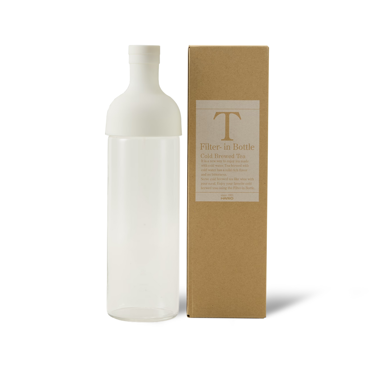 A clear bottle with a white cap stands next to a brown box labeled Filter-in Bottle Cold Brewed Tea on a white background.