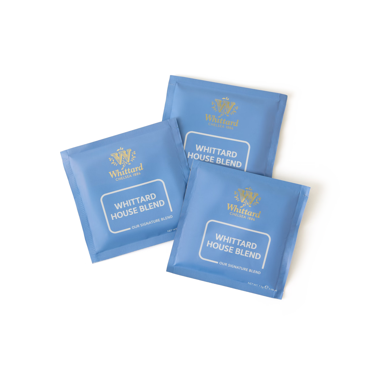 Three blue packets of Whittard House Blend Coffee Bags are arranged on a white background. Each packet is labeled “Whittard House Blend Our Signature Blend” with the Whittard logo in gold at the top, evoking the elegance of premium house blend and expertly crafted Brazilian and Colombian coffees.