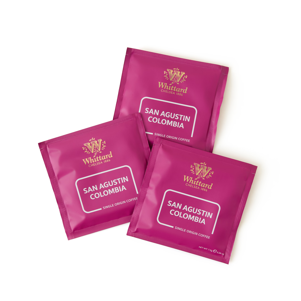 Three magenta packets of San Agustin Colombia Coffee Bags are arranged on a white background. Each compostable coffee bag displays the brand logo and coffee details in white text.