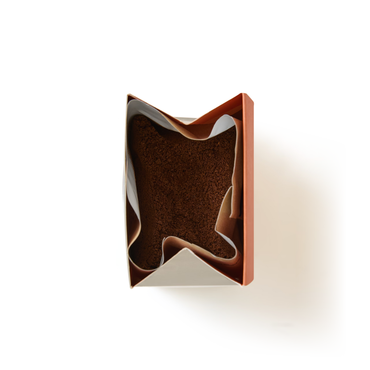A rectangular box of Salted Caramel Flavoured Ground Coffee is partially wrapped in white parchment paper and viewed from above against a plain white background.