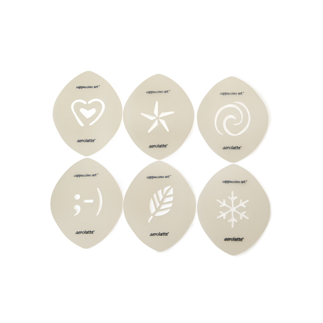 Six cappuccino art stencils with cut-out designs: heart, star, swirl, winking face, leaf, and snowflake, arranged in two rows on a light background.