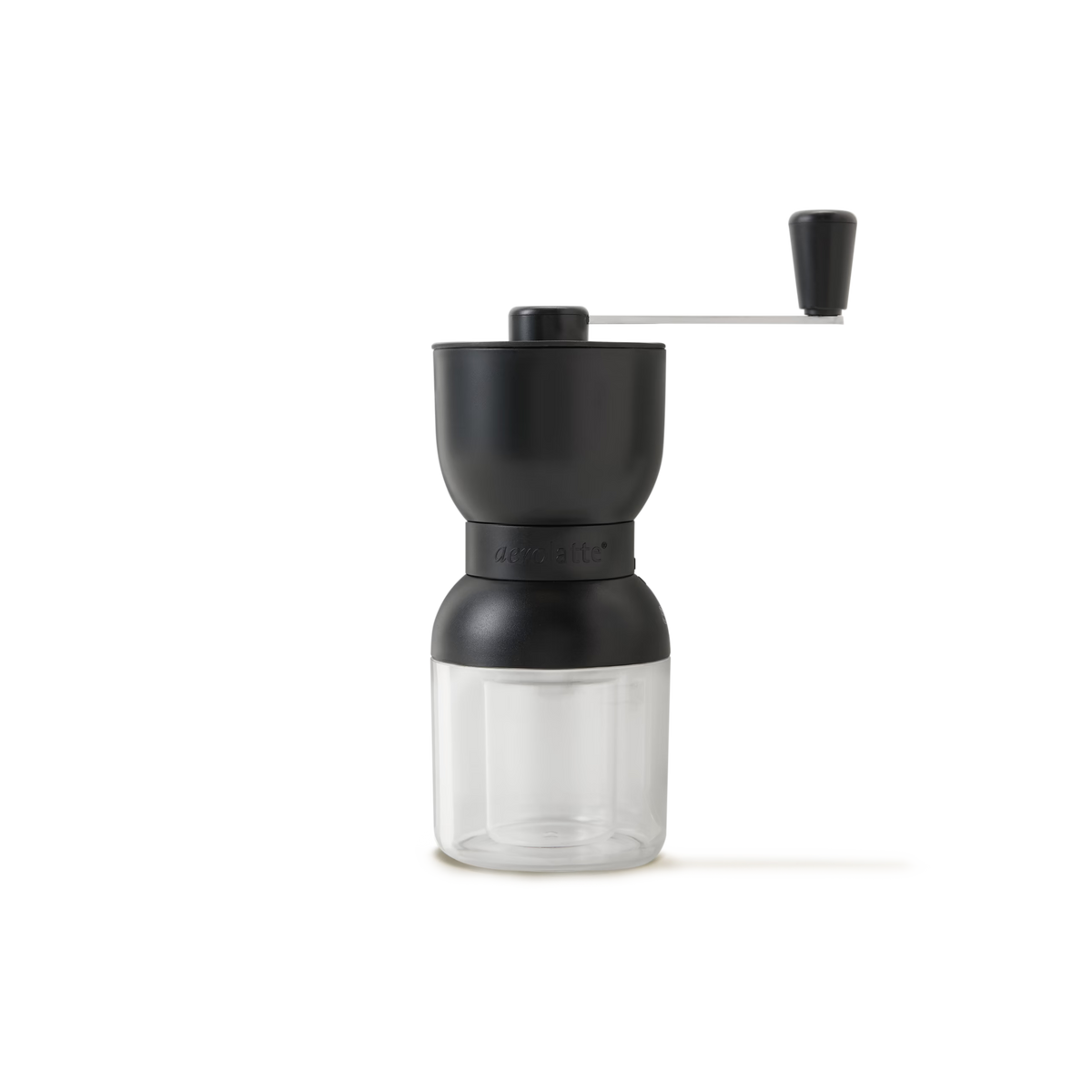 A manual coffee grinder with a black top, clear bottom container, and a metal handle with a black knob, set against a plain white background.