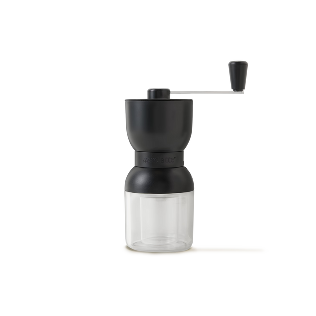 A manual coffee grinder with a black top, clear bottom container, and a metal handle with a black knob, set against a plain white background.
