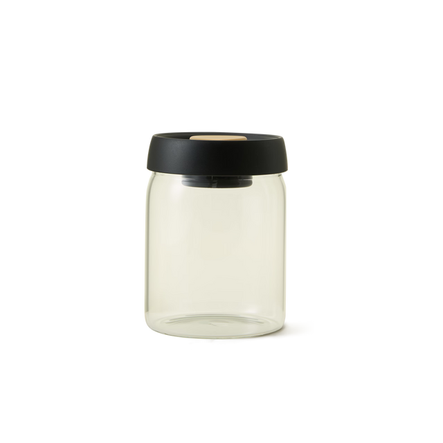 A clear glass jar with a black lid, shown against a plain white background.