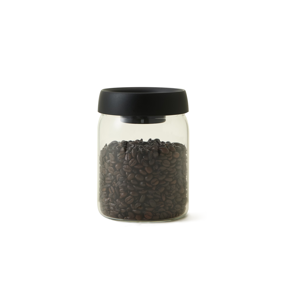 The Airtight Coffee Jar, made of clear glass with a black lid and designed to keep coffee fresh, is half-filled with dark roasted coffee beans and set against a plain white background.