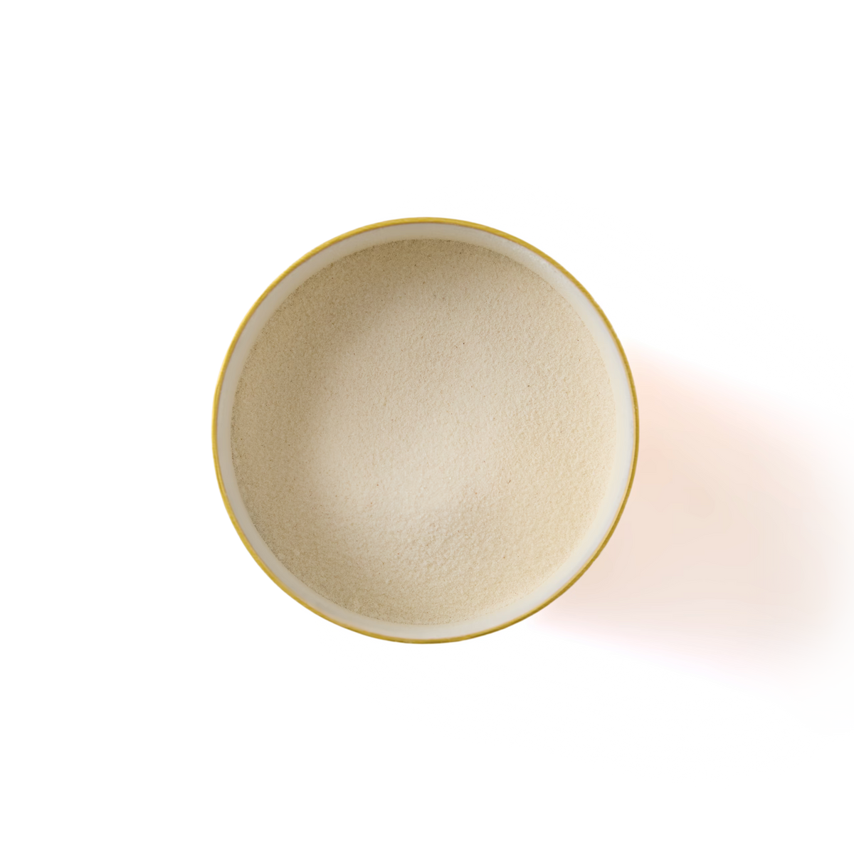 A yellow-rimmed bowl filled with fine, light beige powder, viewed from above, placed on a white background with a soft shadow to the right.