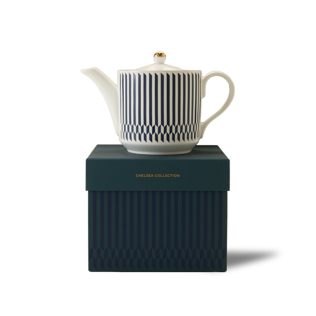 A white teapot with blue vertical stripes sits on a matching dark blue box labeled Chelsea Collection against a plain white background.