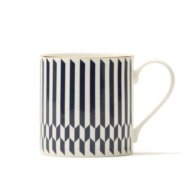 Introducing The Sloane Mug—a white ceramic mug adorned with a sophisticated geometric pattern featuring vertical blue stripes and 3D cube designs, reflecting the timeless elegance of British craftsmanship. With its handle positioned on the right and set against a plain white background, The Sloane Mug is perfect for those who desire a luxurious touch in their daily routine.