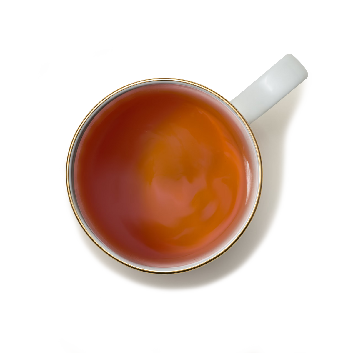 A white ceramic cup filled with tea, viewed from above, sits on a white background with a faint shadow.