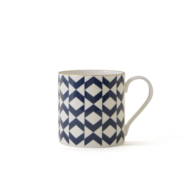 The Regency Mug, a white ceramic mug featuring a blue geometric pattern of triangles and diamonds inspired by elegant British ceramics, is displayed against a plain white background.