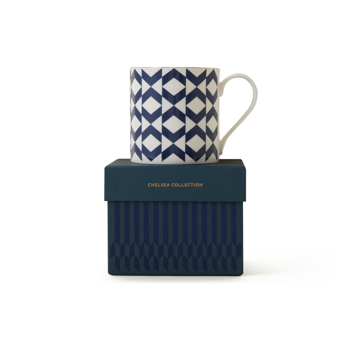 A white The Regency Mug featuring a blue geometric pattern and refined 22ct gold detailing rests atop a dark blue box embossed with “CHELSEA COLLECTION” in gold lettering. Both the mug and the box showcase coordinated pattern designs, embodying the enduring elegance of British ceramics.