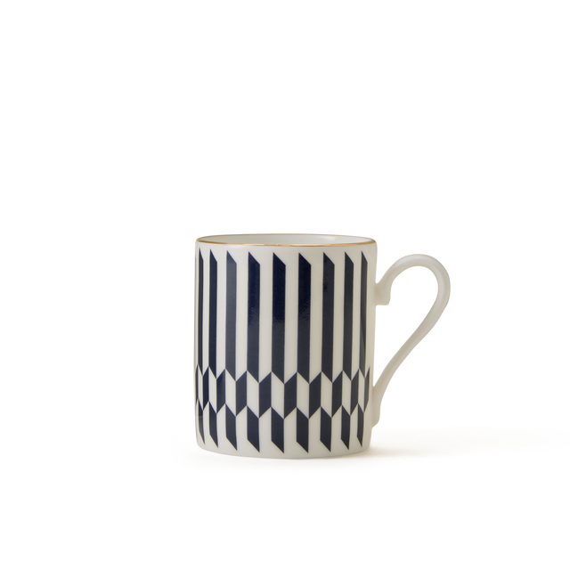 A white ceramic mug with a handle, featuring a geometric black and white vertical striped pattern, displayed against a plain white background.