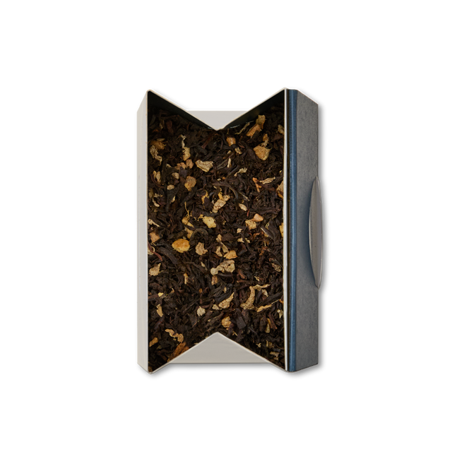 A rectangular box of Ginger Chai Loose Leaf Tea, opened to show a blend of black tea and small dried ginger pieces, viewed from above against a white background—a true winter warmer.
