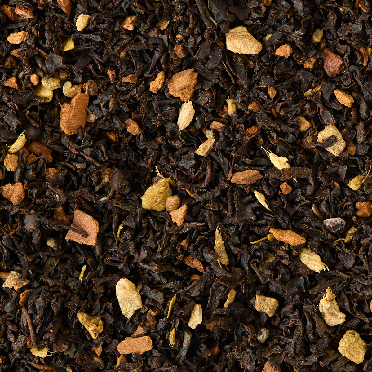 A close-up of Earl Grey Chai Loose Leaf Tea reveals a vibrant blend of black tea infused with dried spices like cinnamon, ginger, and cardamom, creating a colorful and textured mix often enjoyed as chai. This combination showcases the rich tradition of spiced Earl Grey chai that captivates both the eyes and senses.