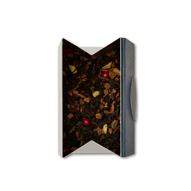 Chai Latte Loose Leaf Tea featuring reddish pink berries, presented in an open rectangular box and photographed from above against a plain white background. Ideal for crafting authentic cafe-style chai or savoring a delicious chai latte at home.