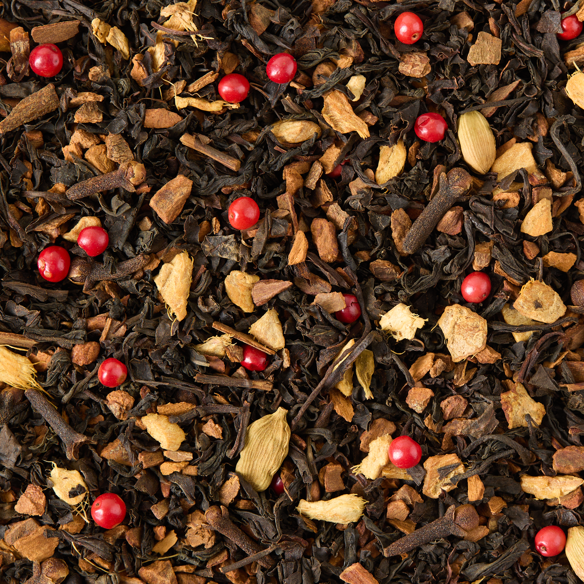 Chai Latte Loose Leaf Tea features visible black tea leaves, cardamom pods, pink peppercorns, cloves, ginger, and cinnamon pieces—ideal for brewing a café-style chai or a cozy chai latte at home.
