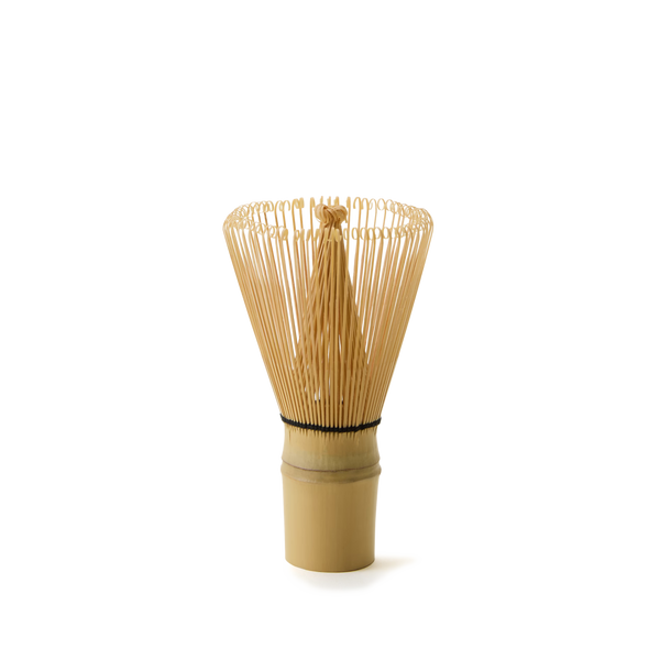 The Bamboo Matcha Whisk stands upright on a plain white background—an ideal choice for those looking for authentic tools for traditional matcha preparation.