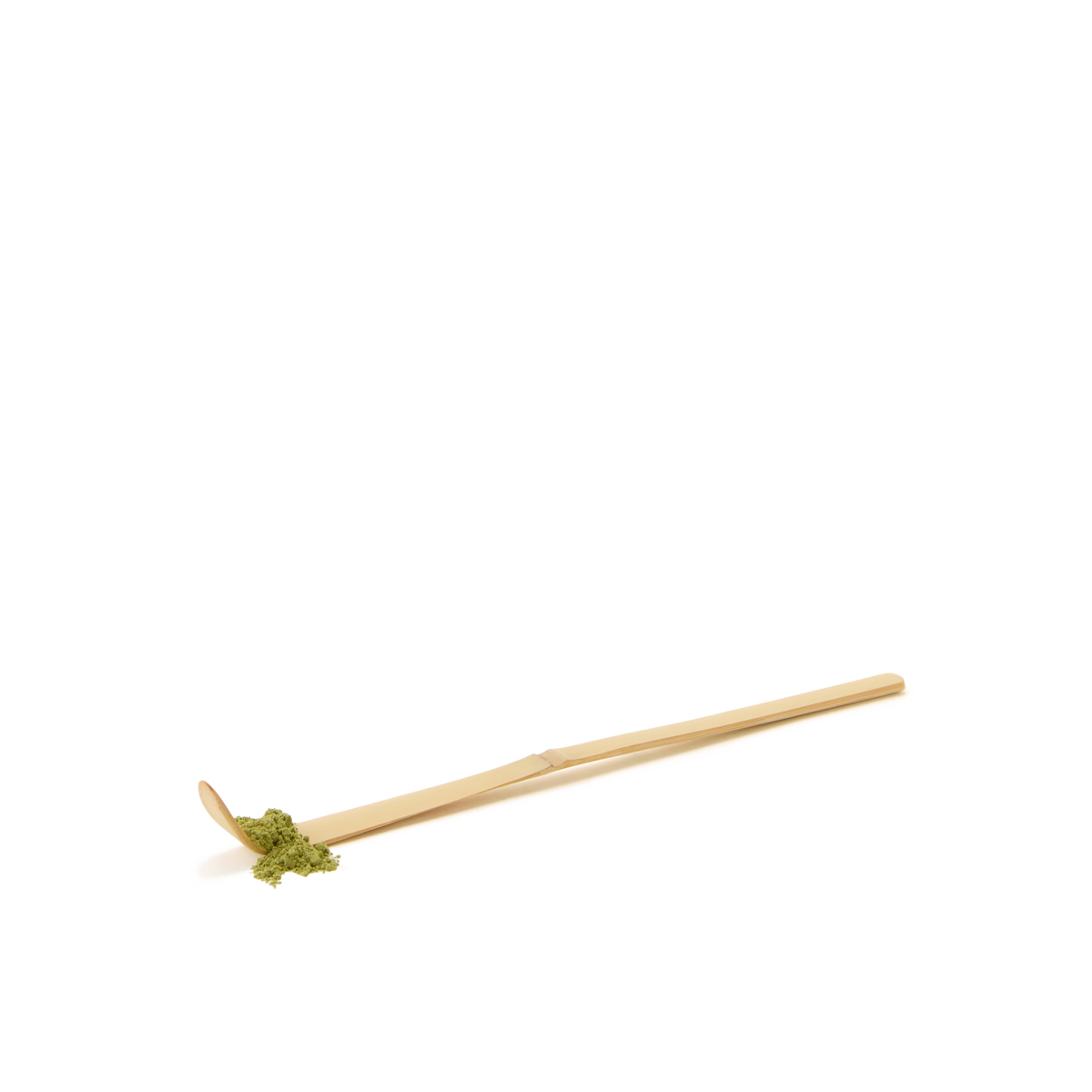 A Bamboo Matcha Spoon, crafted to resemble a gold-colored bamboo tea scoop and featuring a small scoop at one end containing a portion of green matcha powder, sits on a plain white background—evoking the refined tools used in the Japanese tea ceremony.