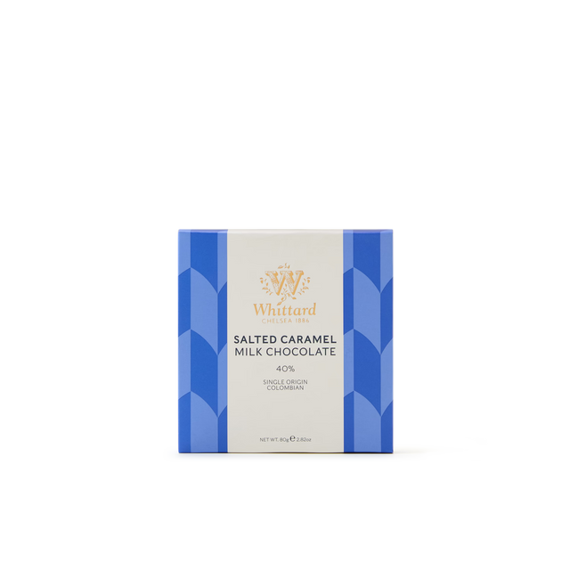 A square box of the Salted Caramel Milk Chocolate Bar, crafted with single-origin Colombian cocoa, featuring a blue geometric design and a gold logo on a light background.