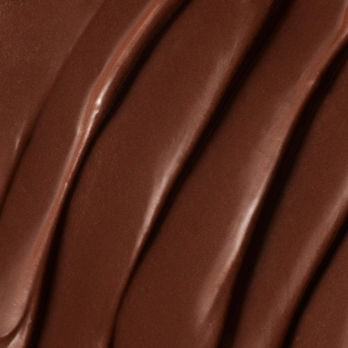 Close-up of a Milk Chocolate Bar featuring smooth, rich Colombian milk chocolate with four thick, wavy lines creating a textured pattern on the surface.